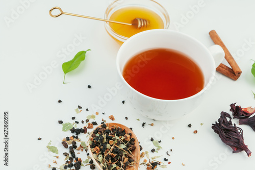  layout made of cup of black tea and leaves on a white background. Top view