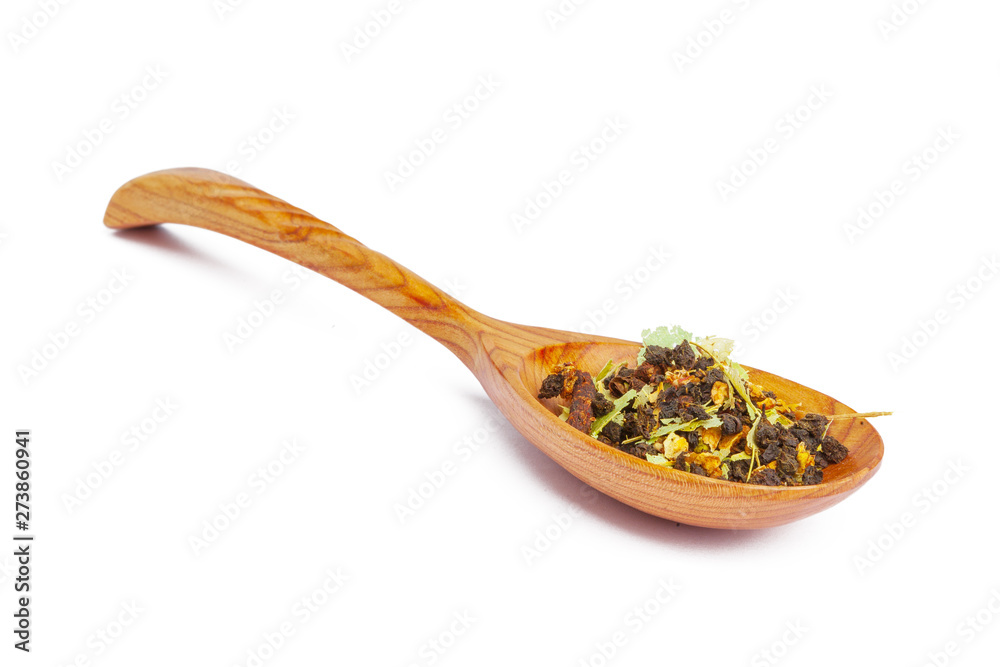Dried tea on a wooden spoon, isolated on white Dried tea on a wooden spoon, isolated on white