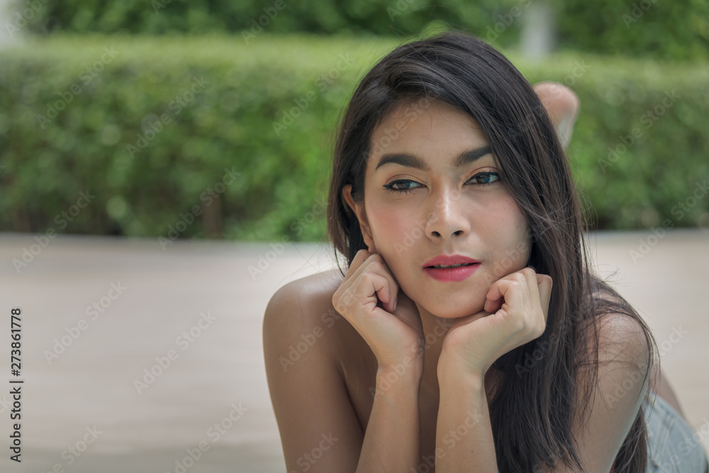 Asian beautiful women portrait lying beside the pool on a relaxing day Asian beautiful women portrait lying beside the pool on a relaxing day