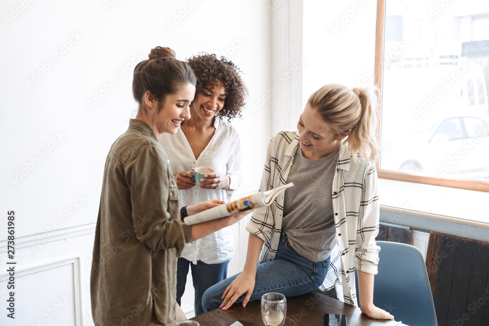 Group of cheerful young women studying together Group of cheerful young women studying together