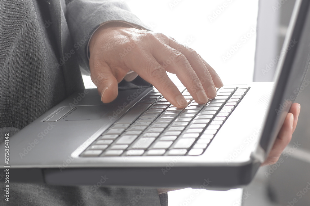 close up.businessman typing on a laptop keyboard.isolated on white background close up.businessman typing on a laptop keyboard.isolated on white background