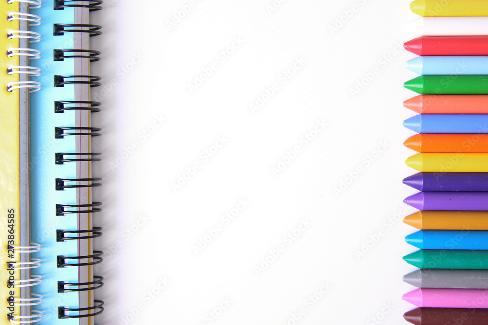 School supplies background,colorful crayons on white.
