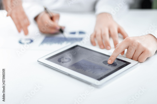 close up.businessman pointing with pen on a digital tablet screen.