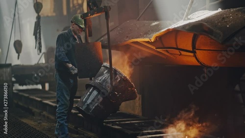 Hard work in the foundry. Pouring molten steel. Liquid steel pouring. Molten metal pouring, metallurgy, steel casting foundry. Steel manufacturing
