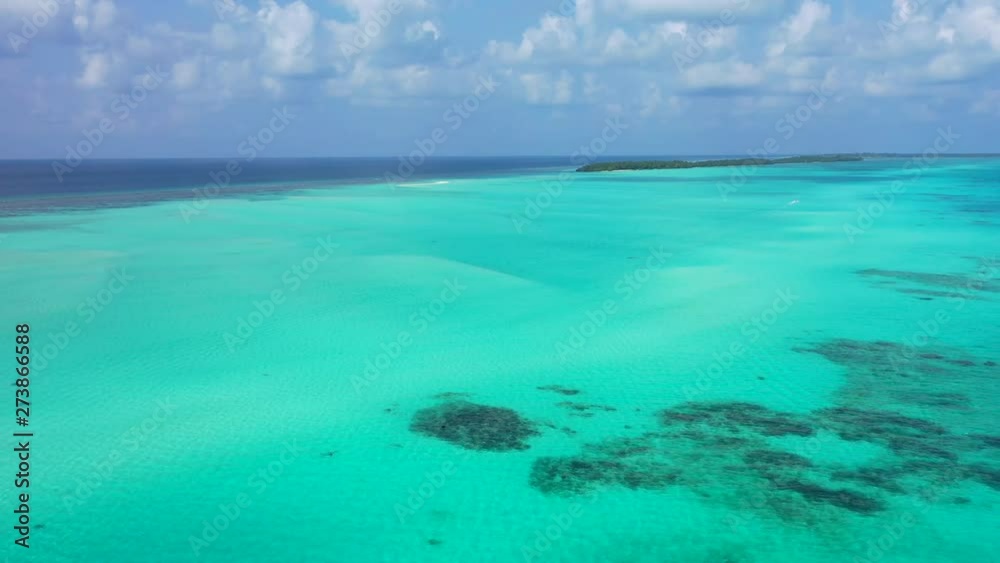 Aerial View Of A Coral Reef In A Pacific Lagoon with crystal clear water, drone shot Aerial View Of A Coral Reef In A Pacific Lagoon with crystal clear water, drone shot