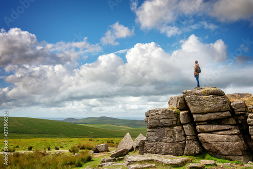 Obraz na płótnie Young man standing on South Hessary Tor near Princeton, looking at the view in D