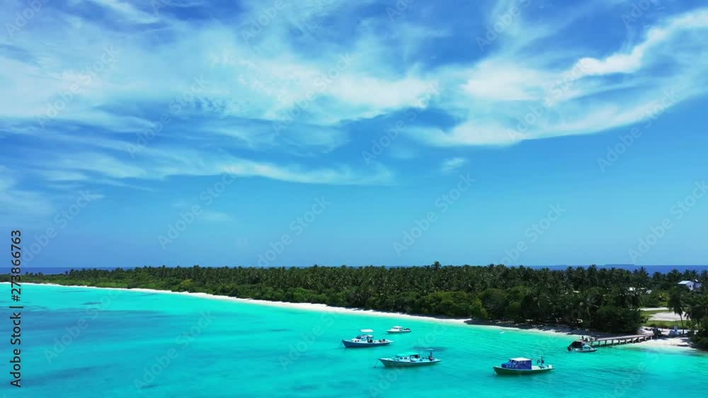 aerial parallax drone shot over tropical island with fishing and tour boats moored in crystal clear waters of caribbean sea aerial parallax drone shot over tropical island with fishing and tour boats moored in crystal clear waters of caribbean sea