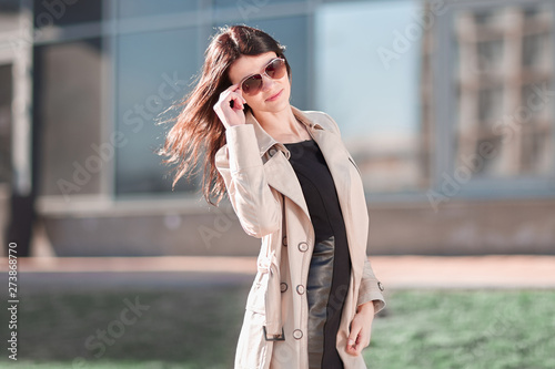 young business woman standing on the street near the office building