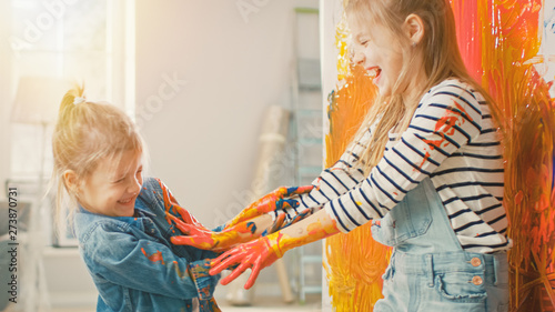 Wallpaper Mural Two Fun Little Sisters Play and Fool Around with Their Hands Dipped in Colorful Paint. They are Happy and Laugh. Sisterhood Goals. Redecoration at Home. Torontodigital.ca