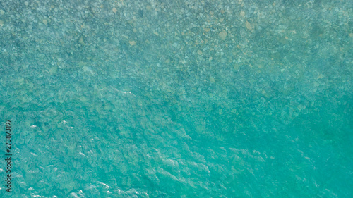 Aerial view of sea surface. Top view of transparent turquoise ocean water surface.