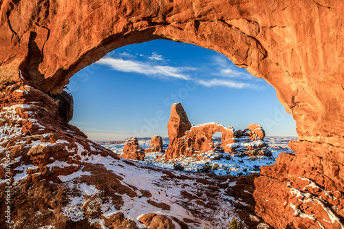 sunrise of North Window Arch and Turret Arch after snow in Arches National Park
