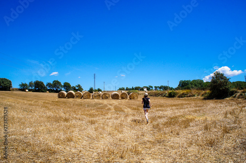 Fototapeta Naklejka Na Ścianę i Meble -  Countryside in Spain. Catalan village. Haystacks and blue summer sky. Tourist in the village. Fun and travel in Europe