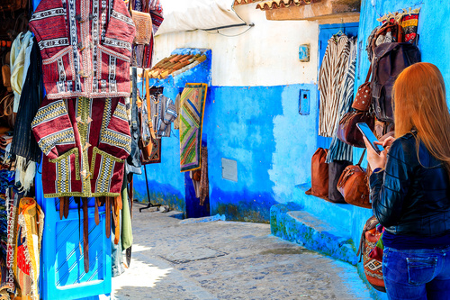 Colorful Moroccan fabrics and handmade souvenirs on the street in the blue city Chefchaouen, Morocco, Africa..