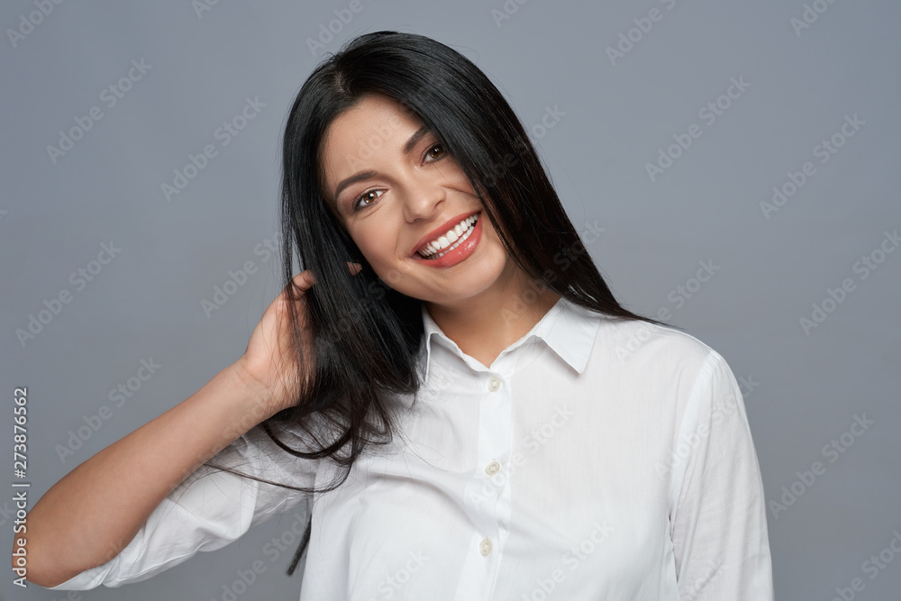 Cheerful, pretty model with long black hair posing. Cheerful, pretty model with long black hair posing.