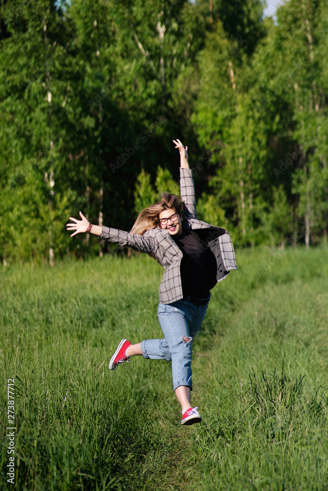 Young beautiful asian girl having fun and jumping in the forest Young beautiful asian girl having fun and jumping in the forest