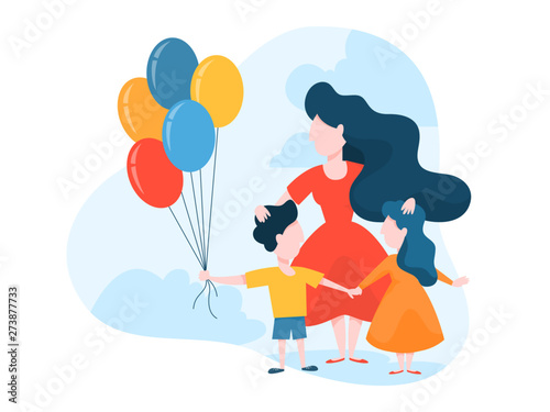 Mother standing with children holding balloon
