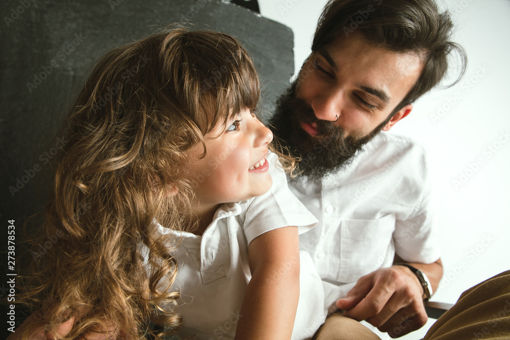 Father playing with young son in their sitting room at home. Young dad having fun with his children in holidays or weekend. Concept of parenthood, childhood, father's day and family relationship. Father playing with young son in their sitting room at home. Young dad having fun with his children in holidays or weekend. Concept of parenthood, childhood, father's day and family relationship.