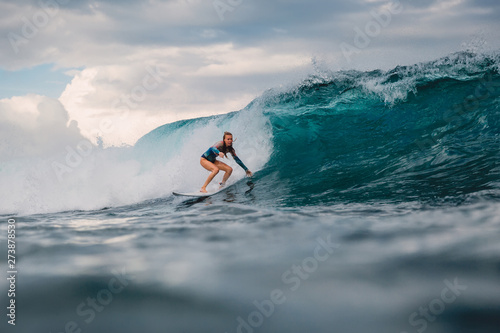 Photography Surf girl on surfboard. Surfer woman and big blue wave