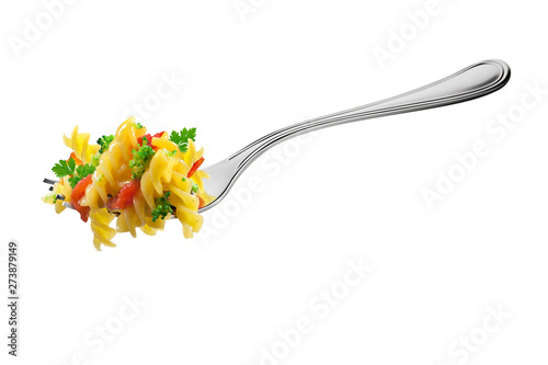 Fork with fusilli pasta broccoli tomatoes and aromatic herbs
