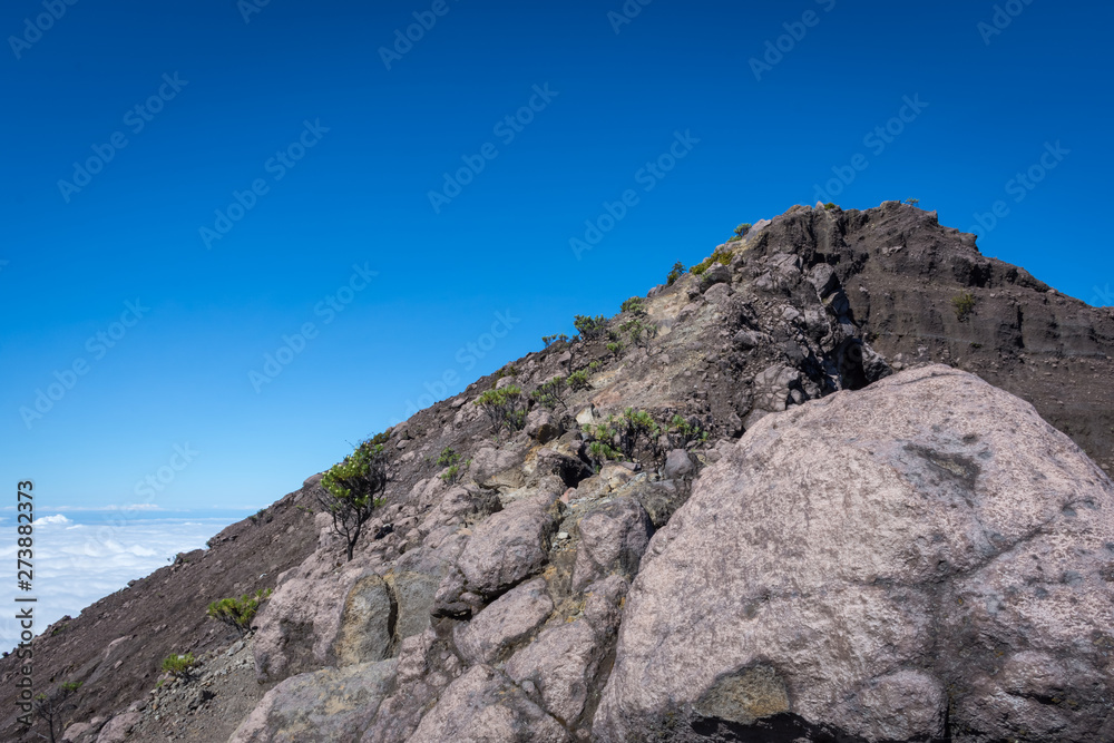 An extreme track to Raung mount summit called 'Puncak Sejati'. Raung is the most challenging of all Java’s mountain trails, also is one of the most active volcanoes on the island of Java in Indonesia. An extreme track to Raung mount summit called 'Puncak Sejati'. Raung is the most challenging of all Java’s mountain trails, also is one of the most active volcanoes on the island of Java in Indonesia.