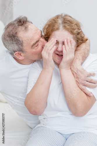 an elderly husband calms a crying wife