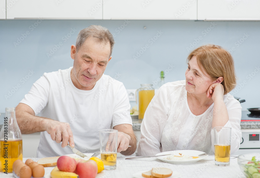 Elderly couple have fun in the kitchen