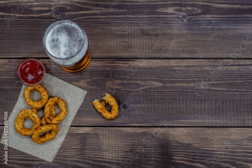Snacks with beer on dark wooden background. Top view. Empty space for text