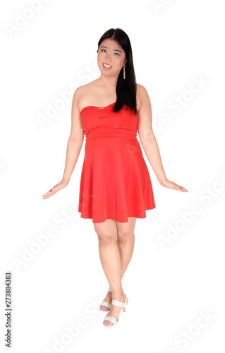 Happy Asian woman in a red short dress smiling