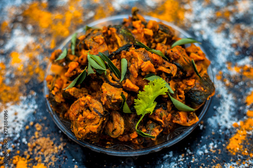 Famous Indian & Gujarati snack dish in a glass plate on wooden surface i.e. Patra or paatra consisting of mainly Colocasia esculenta or arbi ke pan or elephant ear leaves and spices. Horizontal shot. photo