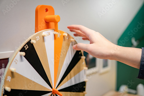 Fotografía Male hand spinning wooden wheel of fortune