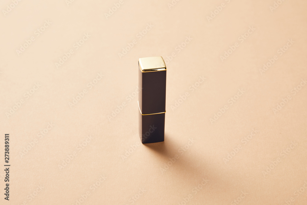one tube of lipstick for makeup on beige one tube of lipstick for makeup on beige