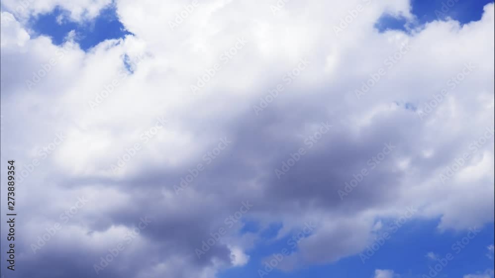 4K Time-lapse motion of puffy fluffy white clouds blue sky background. 4K Time-lapse motion of puffy fluffy white clouds blue sky background.