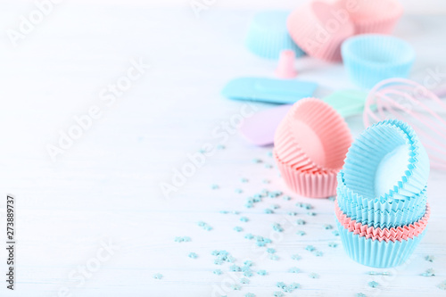 Colorful cupcake cases with sprinkles on white background © 5second