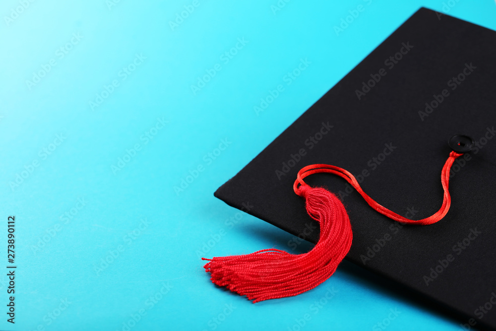 Graduation cap on blue background Stock Photo | Adobe Stock