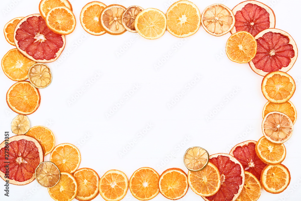 Dried citrus fruits on white wooden table