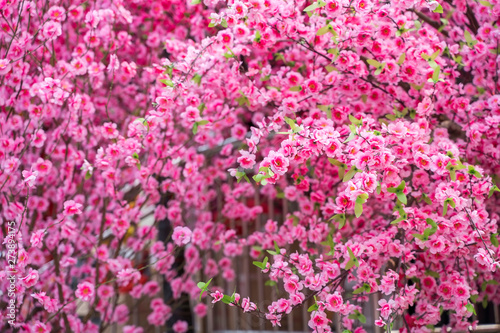 artificial peach blossoms on a branch