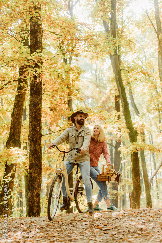 Couple in love ride bicycle together in forest park. Bearded man and woman relaxing in autumn forest. Romantic couple on date. Date and love. Autumn date hike in forest. Romantic date with bicycle Couple in love ride bicycle together in forest park. Bearded man and woman relaxing in autumn forest. Romantic couple on date. Date and love. Autumn date hike in forest. Romantic date with bicycle