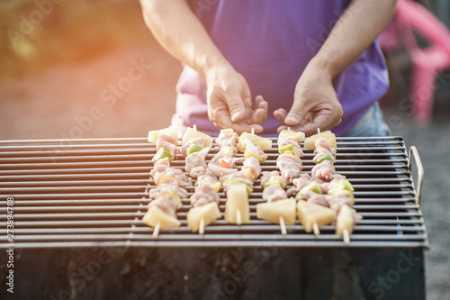 Close-up shots of a man doing a barbecue To wait for friends to come to the party this evening