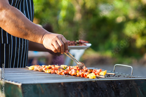 Close-up shots of a man doing a barbecue To wait for friends to come to the party this evening
