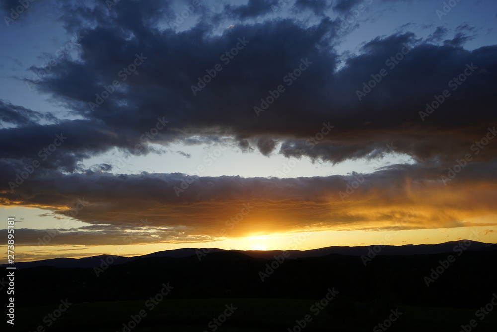 Brilliant Sunset with Clouds Over Mountains Brilliant Sunset with Clouds Over Mountains