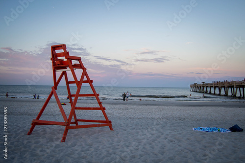 Red life guard chair on the beach © Jazmine
