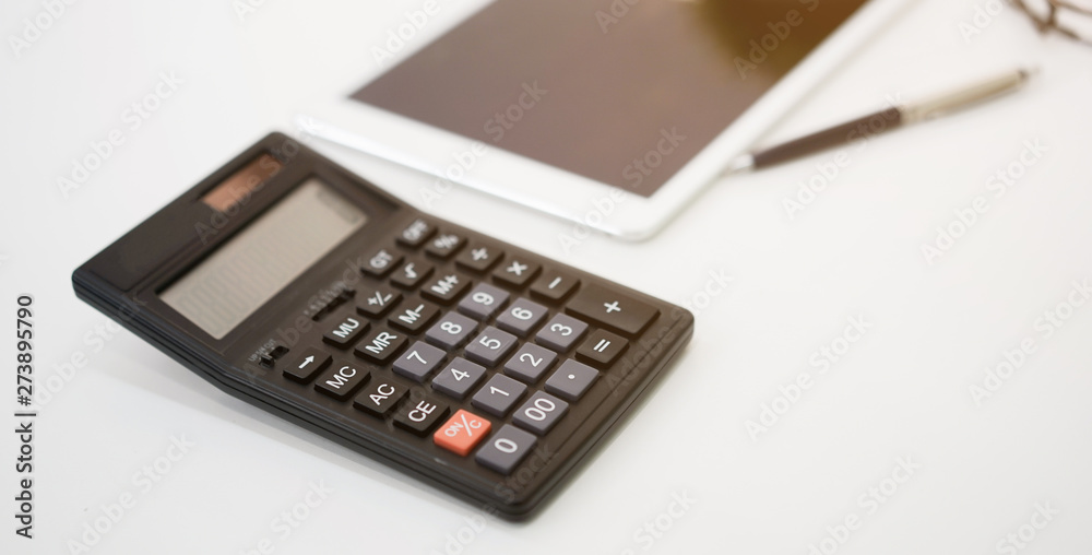 close up calculator with tablet and pen on white table for business financial concept close up calculator with tablet and pen on white table for business financial concept