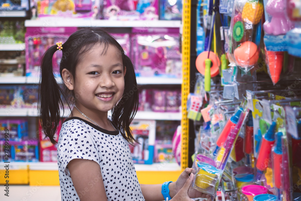 Asian smiling little girl in store Asian smiling little girl in store