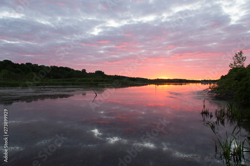Spectacular cloudy sunrise on the Léon-Provancher marsh during springtime, Neuville, Quebec, Canada