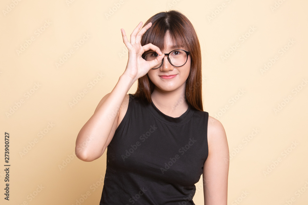 Beautiful young Asian woman show OK sign over her eye. Beautiful young Asian woman show OK sign over her eye.