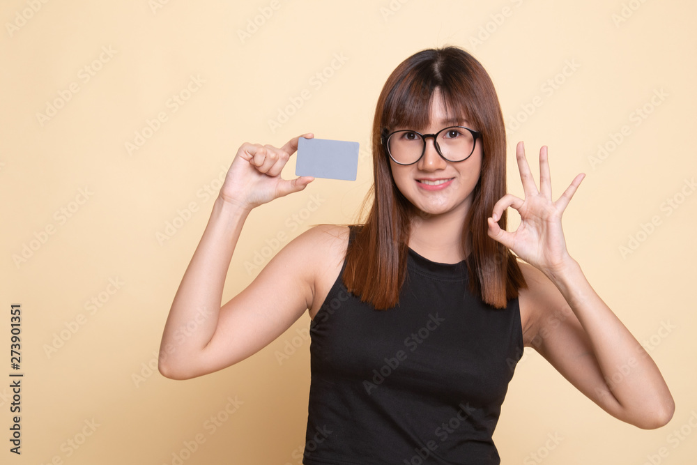 Young Asian woman show OK with a blank card. Young Asian woman show OK with a blank card.