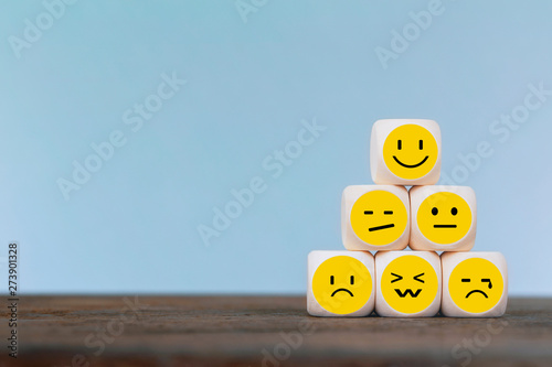 Emoticon icons face on Wooden Cube , Costumer service concept photo