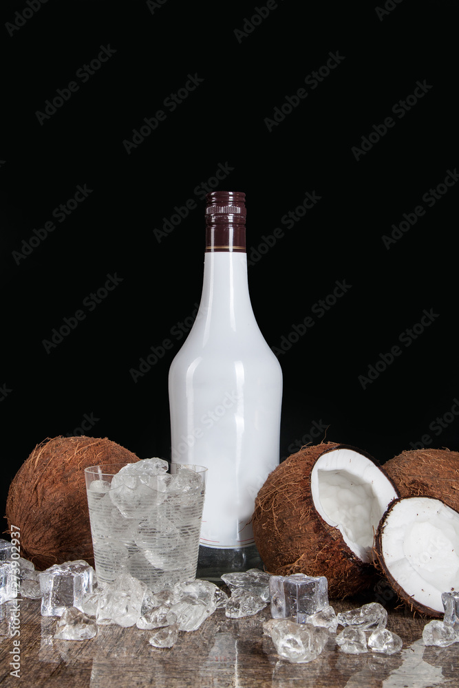 Fototapeta premium coconut with ice cubes on a black background