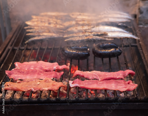 meat and sardines in a grill photo