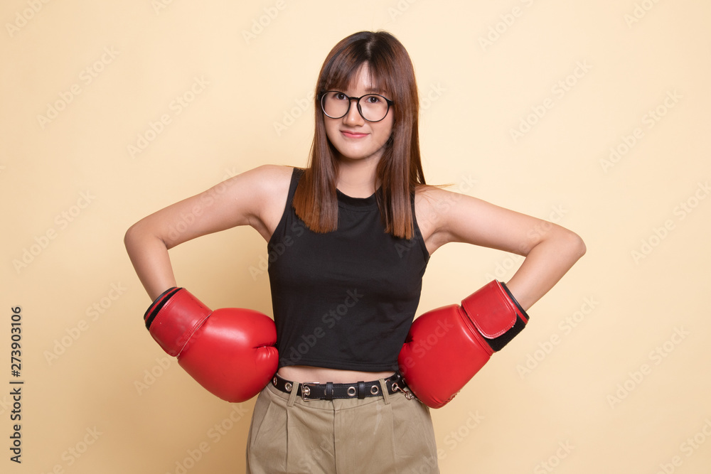 Young Asian woman with red boxing gloves.